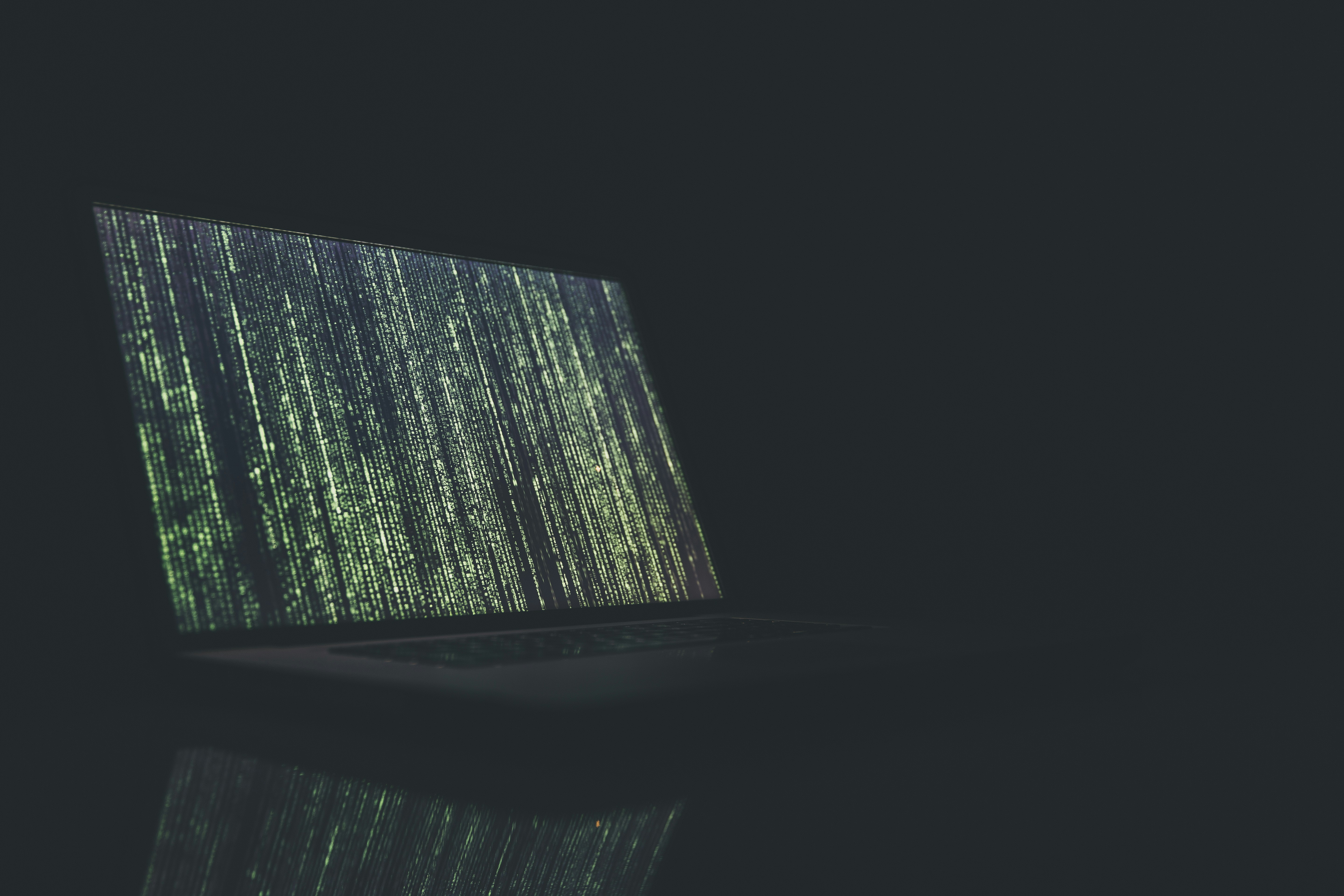 Cybersecurity analyst working in a dim control room